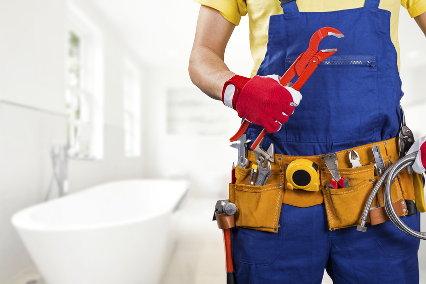 plumber with tool belt standing in bathroom plumber with tool belt standing in bathroom